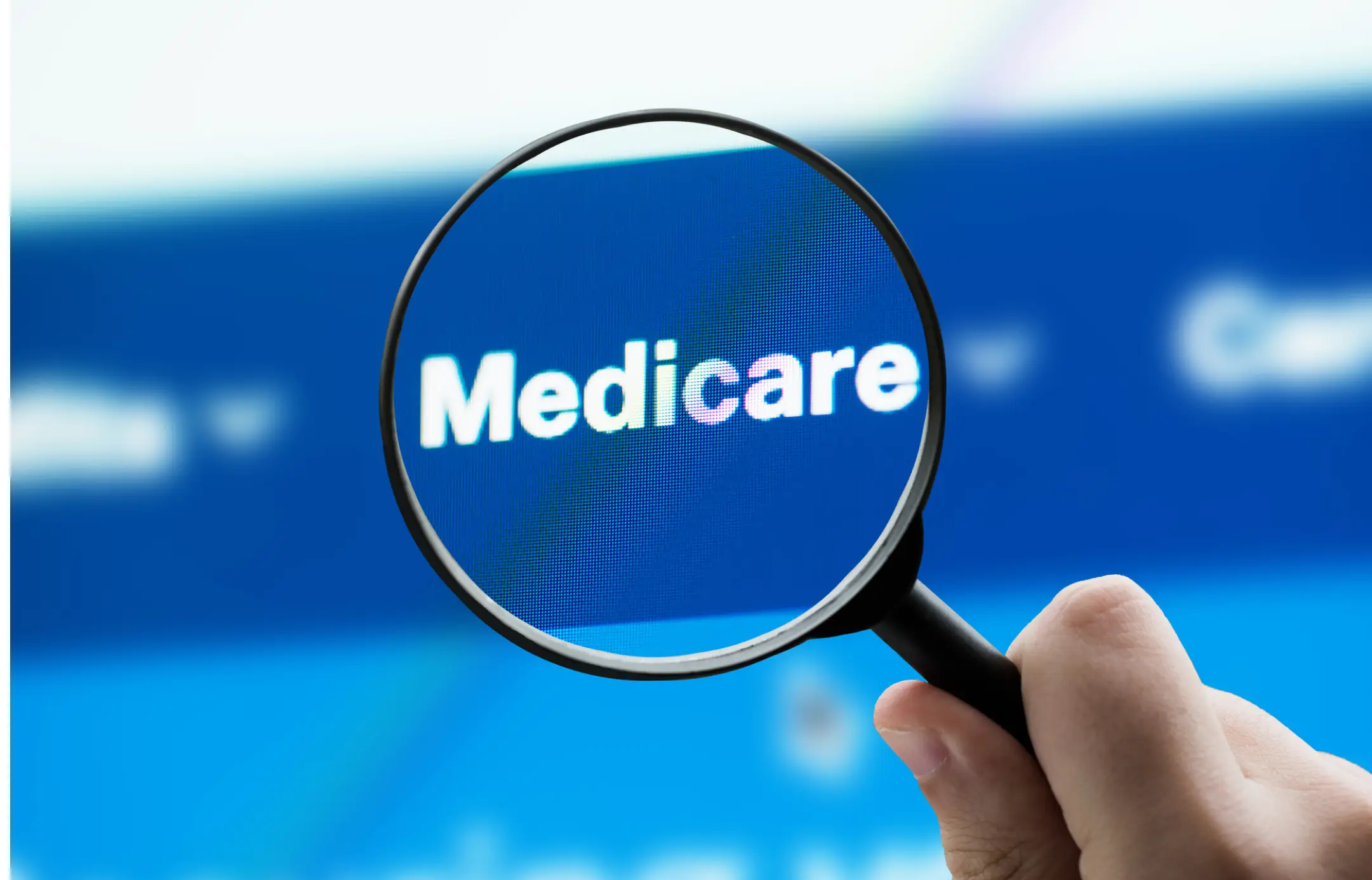 Magnifying glass highlighting Medicare text on screen