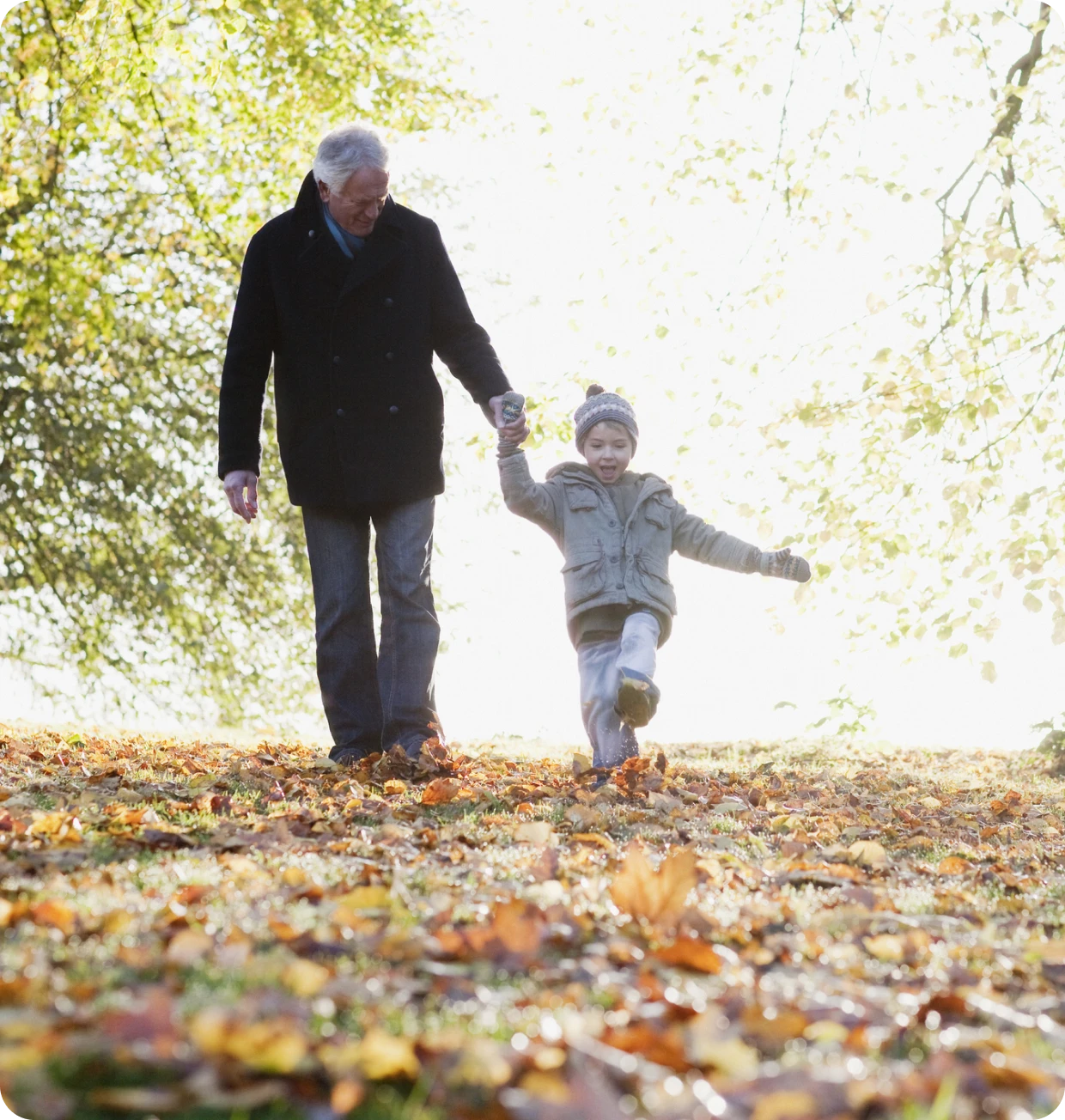 Elderly man and boy enjoying fall day.