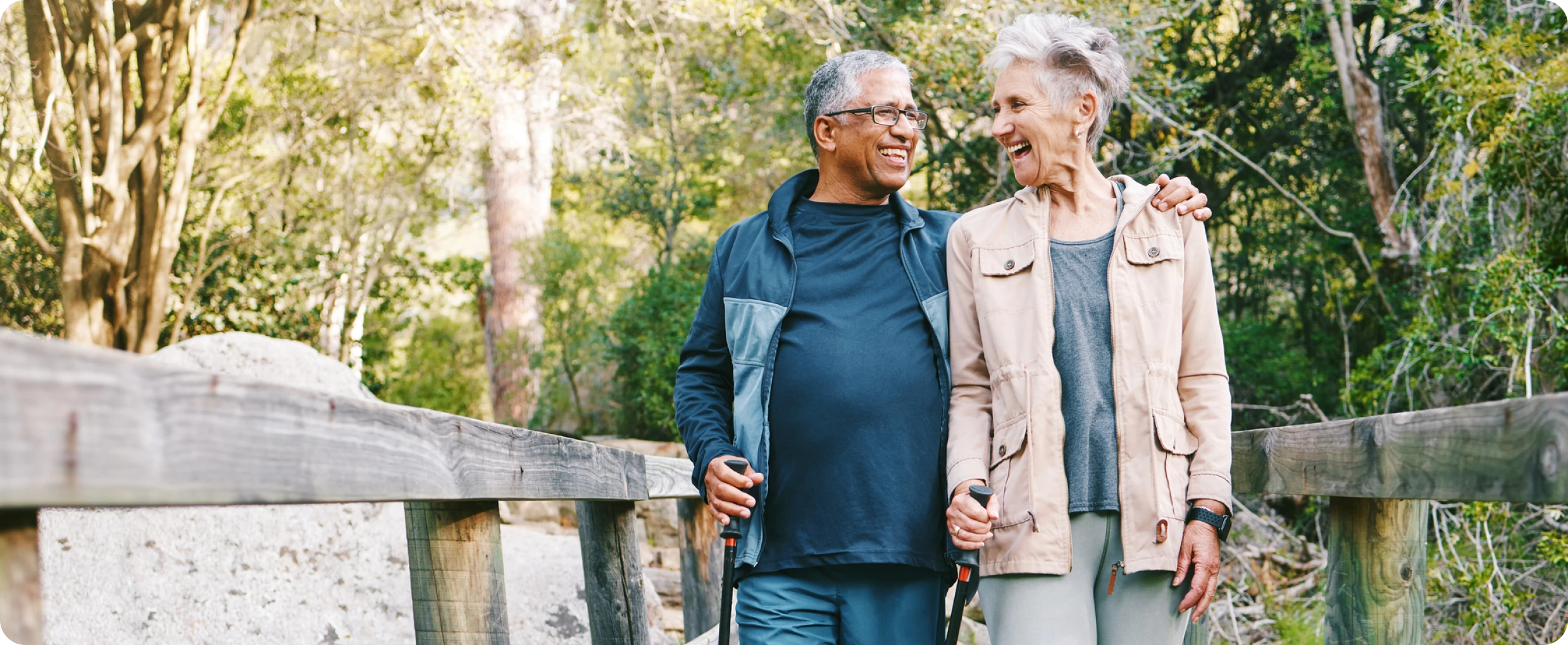 Smiling seniors strolling in a forest setting