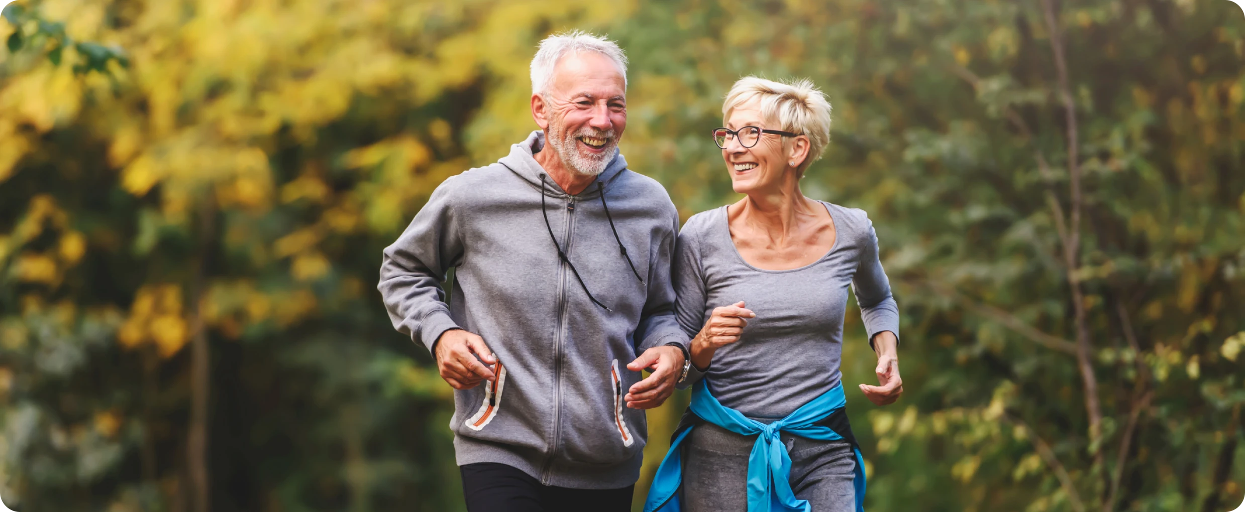 Elderly couple jogging in nature