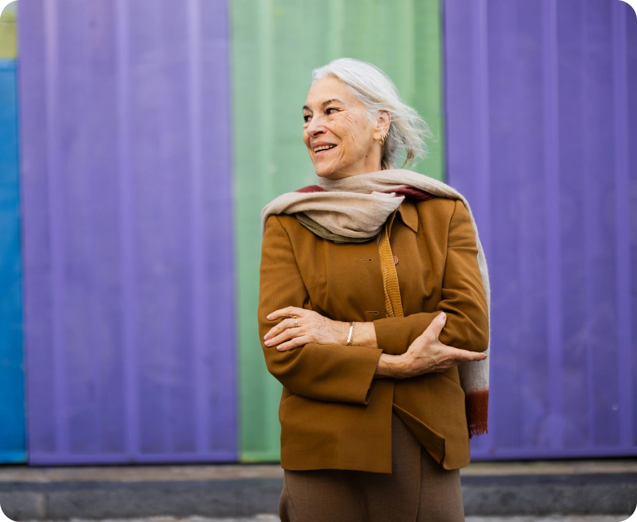 Woman with scarf in front of vibrant wall